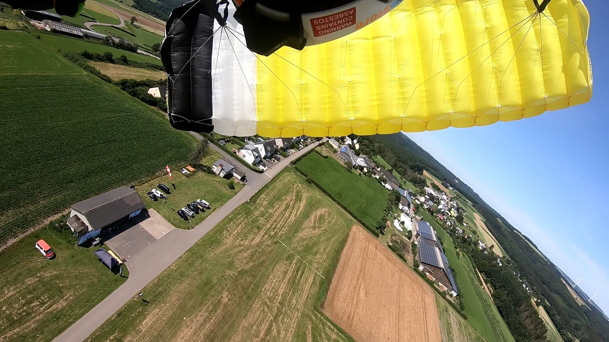 Open parachute over the dropzone
